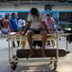 A patient suffering from the coronavirus disease (COVID-19) waits to get admitted outside the casualty ward at Guru Teg Bahadur hospital, amidst the spread of the disease in New Delhi, India.